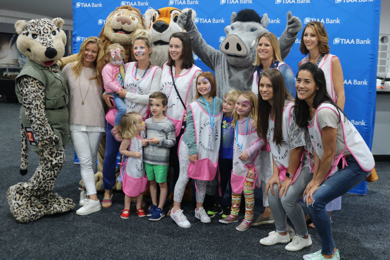 Chairperson Tabitha Furyk (left) and other PGA TOUR wives pose with Jacksonville Zoo characters.